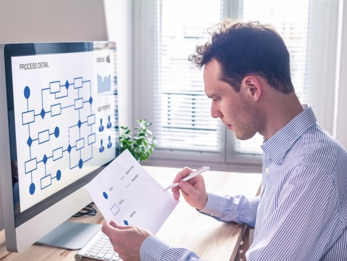 Businessman or engineer working on business process automation or algorithm